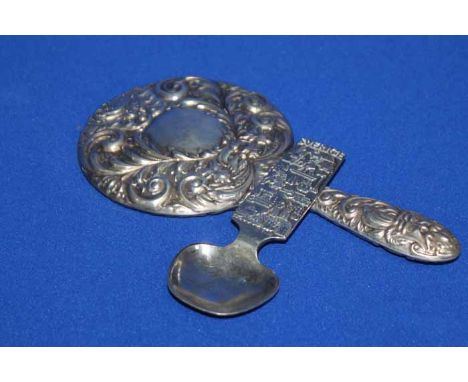 EMBOSSED SILVER HAND MIRROR
decorated in scrolling design with masks and a dove; together with a Swedish silver plated caddy 