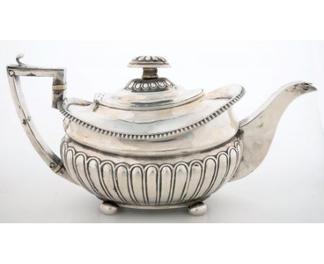 A GEORGE III SILVER TEAPOT OF LOBED OBLONG FORM, ON BUN FEET, 14CM, H, LONDON 1811, 18OZS