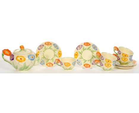 A GRINDLEY ART DECO EARTHENWARE TEA SERVICE, MOULDED IN RELIEF AND PAINTED WITH BRIGHTLY COLOURED FLOWERS, TEAPOT AND COVER 1