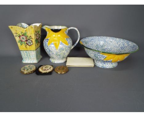 A Poole Pottery wash bowl and jug with floral decoration, an Arthur Wood vase, vintage manicure set and powder compacts.