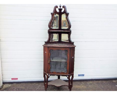 A glazed mahogany corner unit with mirror back upper section, approximately 190 cm x 70 cm x 45 cm.