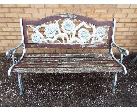 A cast iron and wood slat garden bench with sunflower design to the backrest, approximately 127 cm (l)