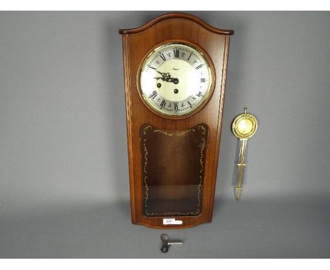 A late 20th century Rapport, Westminster chime, wall clock with key and pendulum, approximately 59 cm (h).