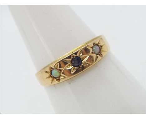 A 15ct gold ring set with a blue stone and two small white opal cabochons, size P, approximately 2 grams all in (shank slight