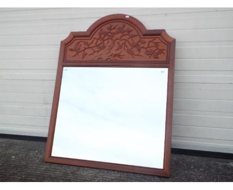A large Chinese style mirror decorated with songbirds and prunus, approximately 115 cm x 90 cm.