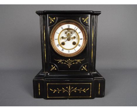 A late 19th century French black slate mantel clock with contrasting incised gold decoration, 4” white enamel dial with Roman