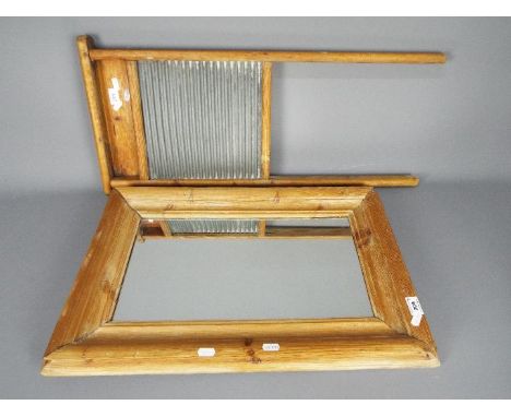A pine framed wall mirror, 62 cm x 42 cm and a pine washboard. [2]