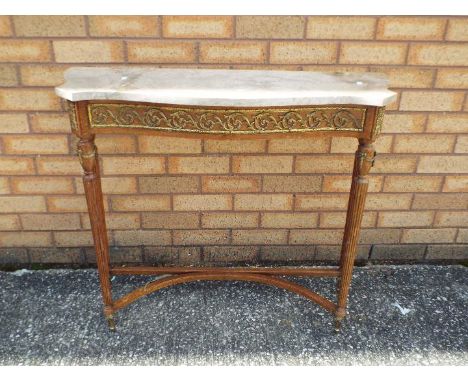 A marble topped console table on fluted supports and with gilt metal mounts, approximately 78 cm x 89 cm x 29 cm.Condition Re