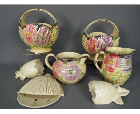 A collection of Art Deco and later ceramics to include Arthur Wood, a Clarice Cliff shell form wall pocket (restored) and fur