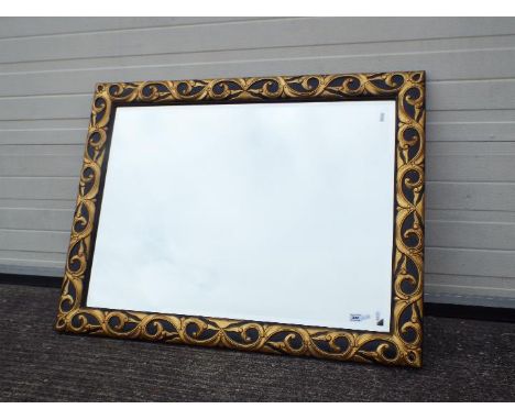 A large bevel edge wall mirror with black and gold coloured frame, approximately 83 cm x 110 cm.