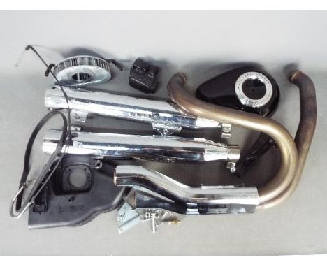 An exhaust system for a Harley - Davidson motorcycle, silencer marked Harley-Davidson Motor Company 64900183 H14-003 e4.