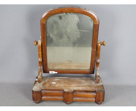 A Victorian toilet mirror with twin drawers to the base and raised on bun feet, approximately 57 cm (h)