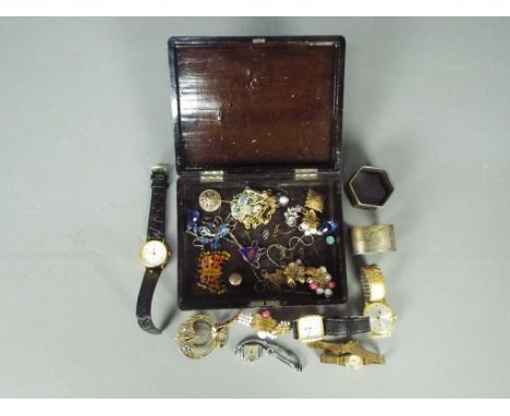 A Japanese lacquered box containing costume jewellery, wrist watches, enamel lapel badge and similar.