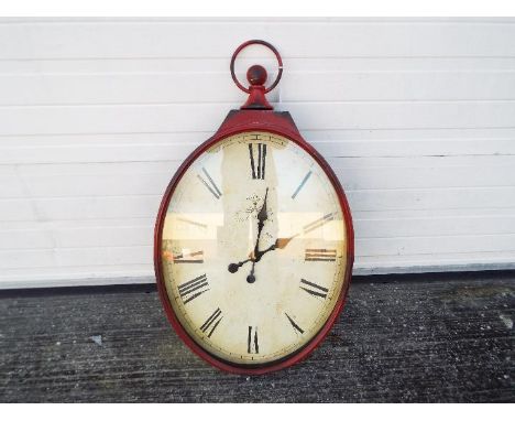 A large, antique style wall clock in the form of a pocket watch, approximately 97 cm x 46 cm.