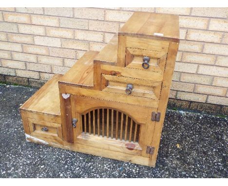 A step cabinet having triple drawers and a cupboard, approximately 72 cm x 77 cm x 45 cm.
