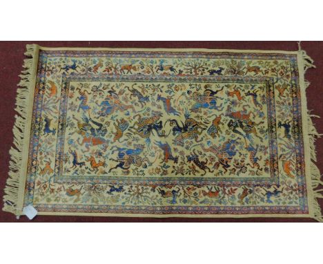 A Persian Qum style&nbsp; rug depicting a hunting scene with deer, set on an ivory field within a border of deer and trees. 1