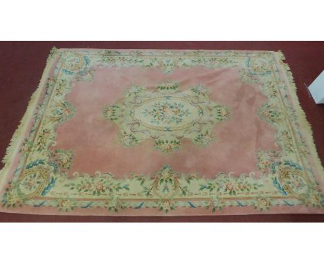 A large vintage Chinese woolen carpet, with floral design on a pink ground,  366 x 255cm 