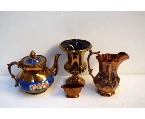 A selection of copper lustreware including a Beswick vase, a tea pot with blue banded thistle design, a small trinket dish an