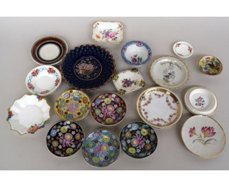 A selection of small china saucers, plates and bowls, mostly decorated with floral motifs on white ground, and including exam