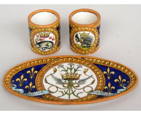 A set of decorative French faience ceramic ware, consisting of an oval tray and two small cups, signed 'Blois' and depicting 
