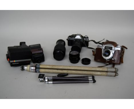 A Canon AE-1 program 35mm camera with Canon zoom lens FD 35-70mm 1:4 in carry case together with a Canon FD 50mm 1:1.8 lens a