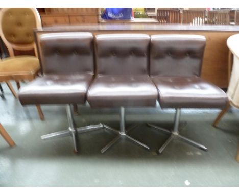 Three vintage button back leather stools with a four-pronged metal base