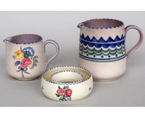 Two 1930s Poole pottery cream jugs in the CS pattern together with a posy ring planter in the same pattern.