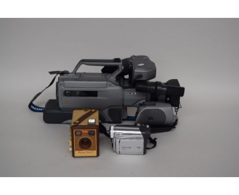 A Kodak 'Brownie' Flash B box camera in case; a Panasonic NV-GS11 digital video camera with case, film, battery charger and a