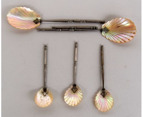 Three early 20th century teaspoons with mother of pearl shell design bowls, together with two dessert spoons of matching desi