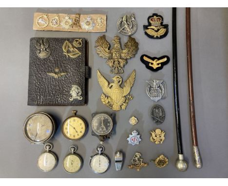 * Military Badges. A mixed collection of militaria, including cap badges, cloth badges, timepieces, stopwatch, RAF swagger st