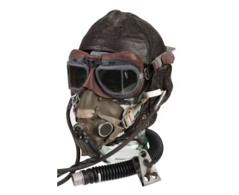 * Flying Helmet. WWII period brown leather flying helmet, brown leather with gosport tubes, presented on a glass head with a 