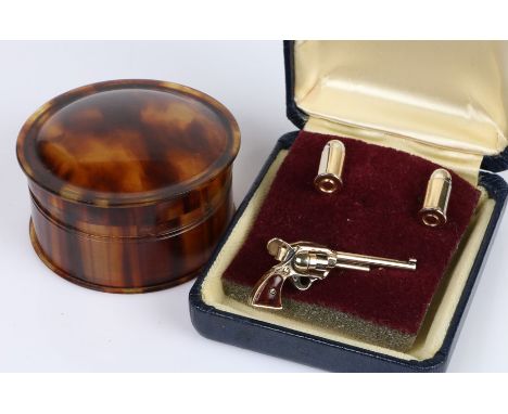 Pair of bullet form cufflinks and a matching tie clip in the form of a revolver, tortoiseshell trinket box and cover