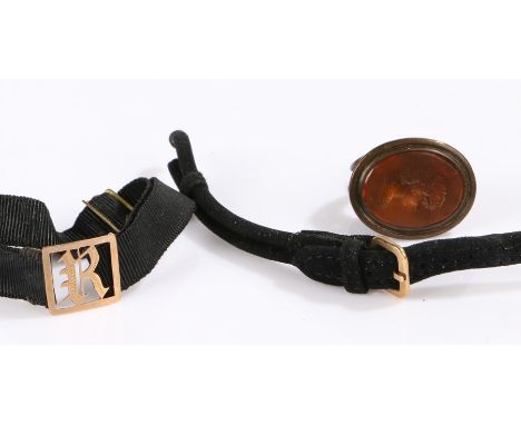 9 carat gold and black silk mourning bracelet, the gold panel with pierced initial R, 9 carat gold watch clasp on a black str