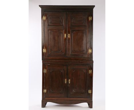 19th Century oak standing corner cabinet, the concave cornice above a pair of fielded panel doors enclosing a shelved interio