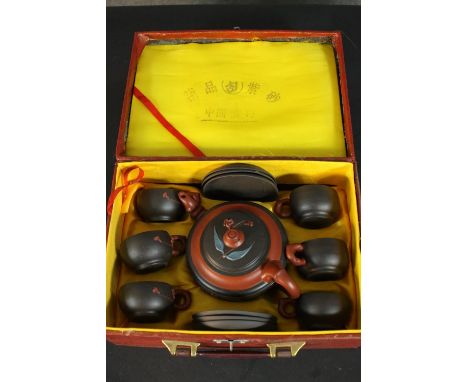 An early 20th century boxed Chinese Yixing tea set consisting of teapot with 6 cups and saucers. Bamboo form handles and reli