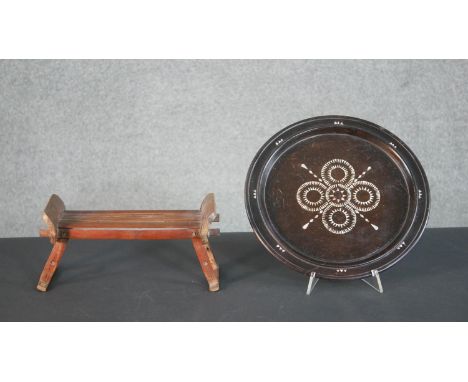 A 19th century Chinese bamboo folding travel head rest along with a carved plate inlaid with a mother of pearl design. Diam.3