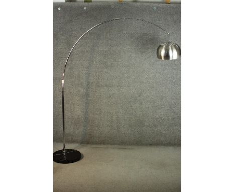 An Arco style adjustable lamp, with an aluminium shade and arm, on a circular black marble base. H.210 W.170cm. (approx.) 