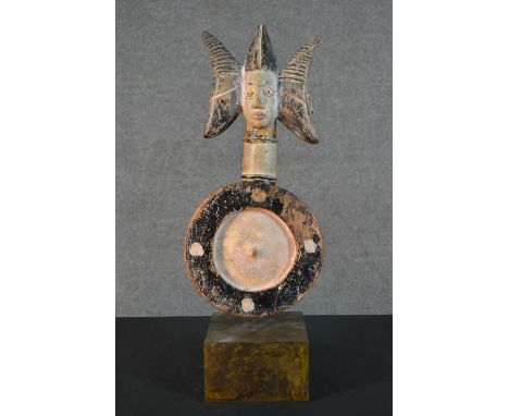An early 20th century painted African tribal divination carving with figural finial. Mounted on a display stand. H.52.5cm (in