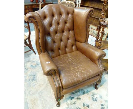 LEATHER ARMCHAIR. Tan leather wingback button back armchair