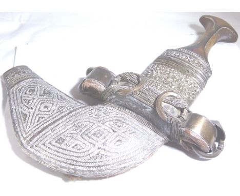 EASTERN DAGGER. Eastern dagger with white metal mounted scabbard