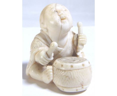 ANTIQUE IVORY NETSUKE. Antique Ivory Netsuke boy with drum - signed to base 
