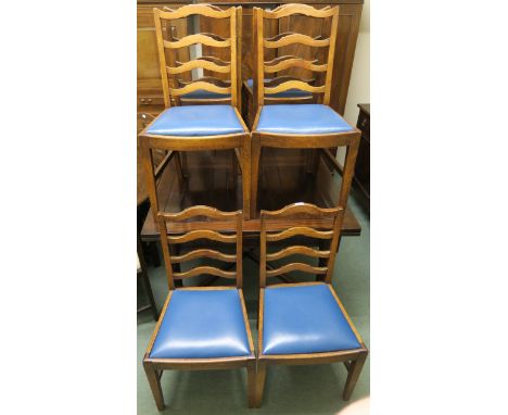 An oak extending dining table, 76cm high x 182cm wide x 107cm deep with six oak ladder back chairs (7) Condition Report: Avai