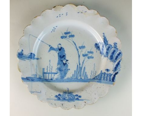 A Bristol delftware blue and white scallop-edged dish, mid-18th century, painted with two Oriental figures within an ornament
