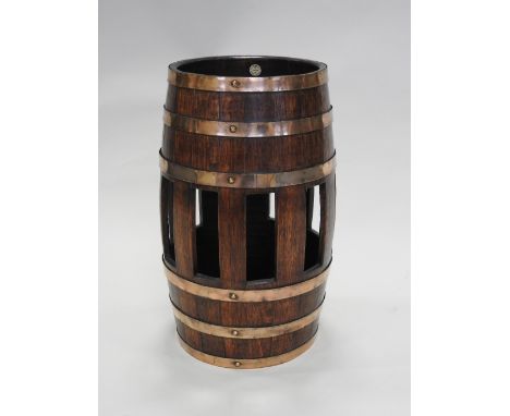 An early 20th century oak coopered stick and umbrella stand, with ivorine label for  R.A. Lister & Co Ltd, Makers Dursley Eng