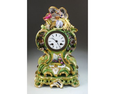 A French porcelain mantel clock and stand, late 19th century, the waisted green-ground case with moulded and pierced gilt bor