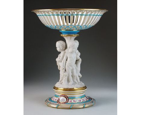 A Minton table centrepiece, circa 1860, the reticulated upper porcelain basket supported by three parian figures representing