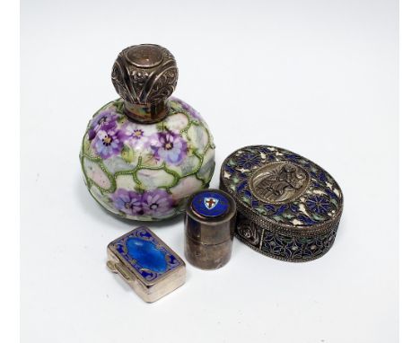 A silver mounted decorative ceramic dressing table jar, M Bros, Birmingham 1912, together with a white metal and blue enamel 