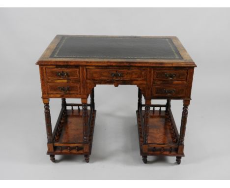 A small late Victorian figured walnut and marquetry desk the rectangular top with tooled leather skiver over a central short 