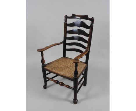 A 19th century Lancashire ash wood wavy ladder back open armchair the shape top rail over five graduated horizontal back spla