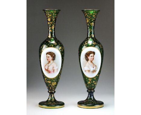 A pair of Bohemian slender glass portrait vases, late 19th century, the green glass finely painted with oval panels of the he